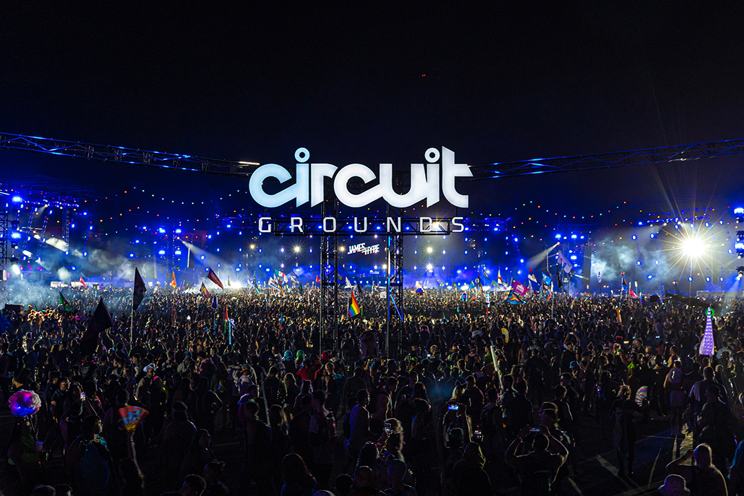 Circuit Grounds stage with a huge crowd with different flags in the air
